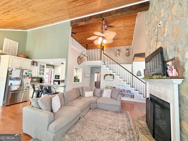 a living room with furniture a fireplace and a rug