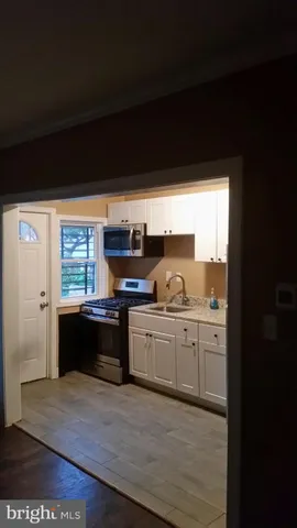a large kitchen with granite countertop a stove top oven