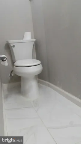 a white toilet sitting next to a white sink