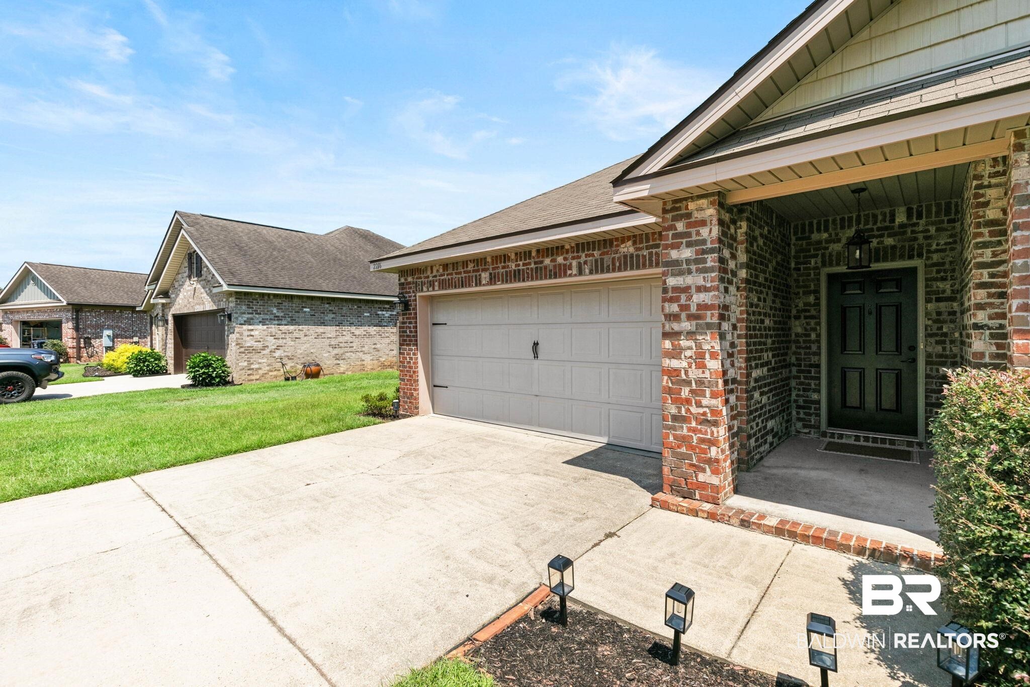 2216 Livingstone Court Mobile, AL 36695 - Photo 3 of 62 Brick and siding exterior featuring an attached garage with a light-colored garage door