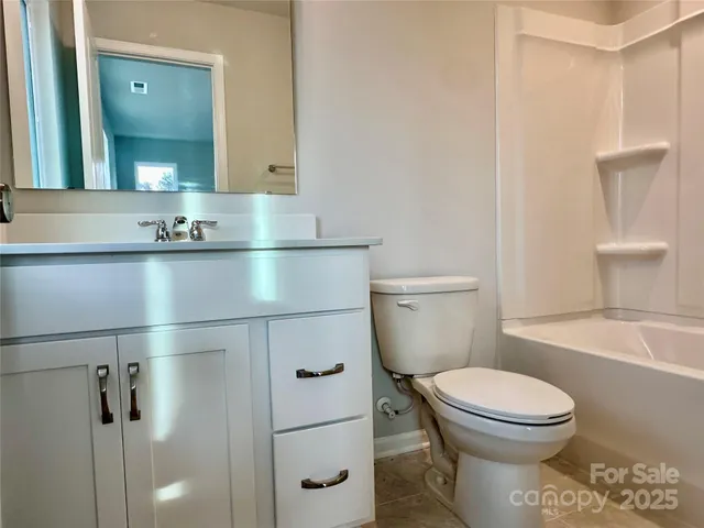 a bathroom with a toilet a sink and bathtub