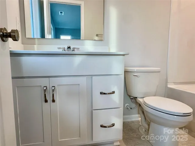 a bathroom with a toilet sink shower and mirror