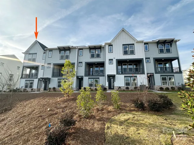 a front view of a residential apartment building with a yard