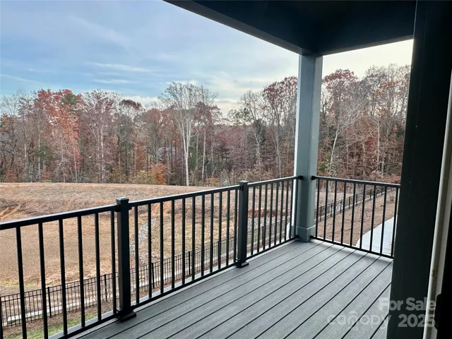 a balcony with wooden floor and roof