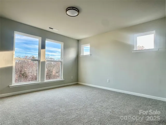 an empty room with a empty space and windows