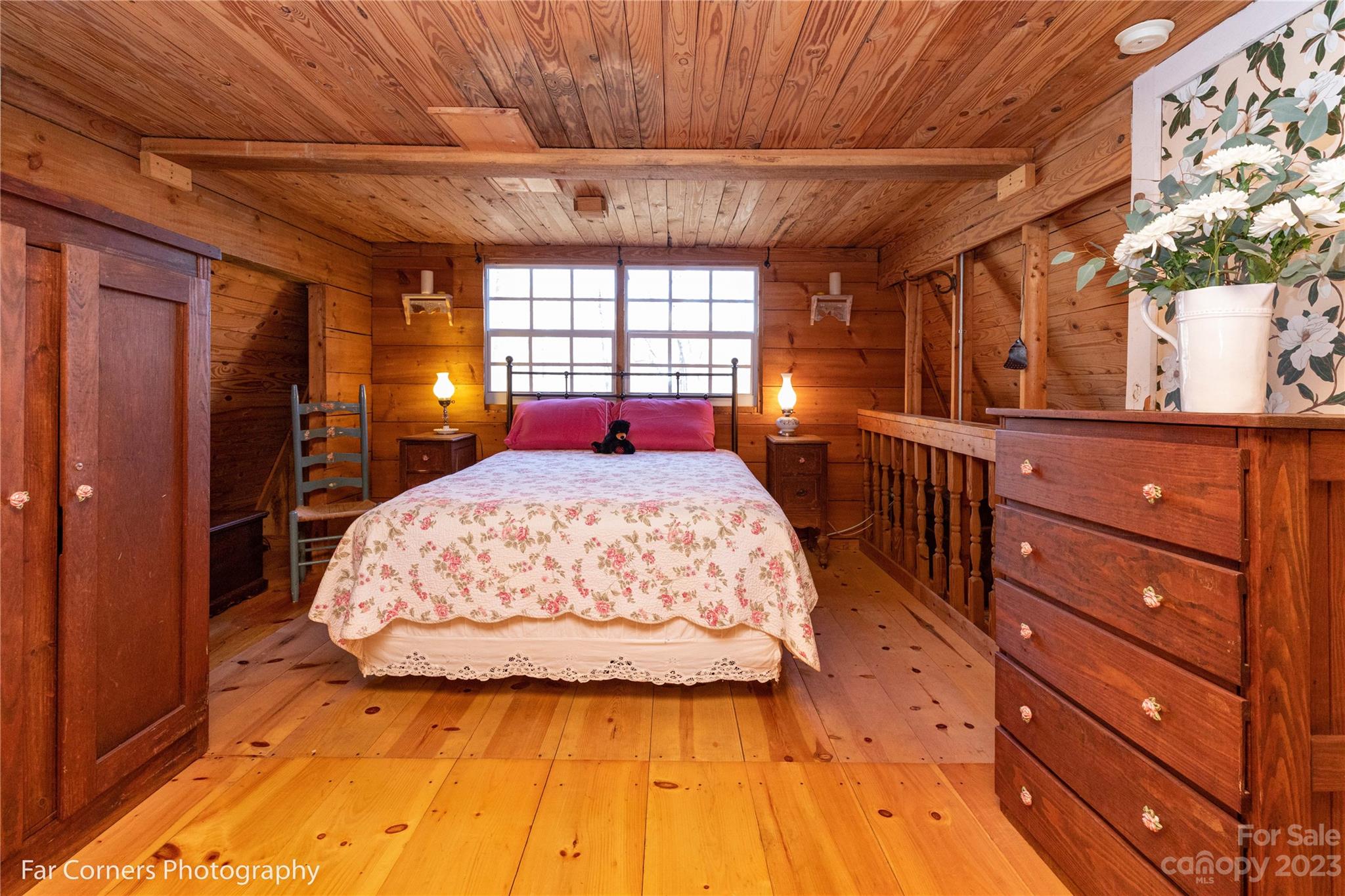 523 Spring Lake Road Maggie Valley, NC 28751 - Photo 17 of 25 a bedroom with a bed and a large window