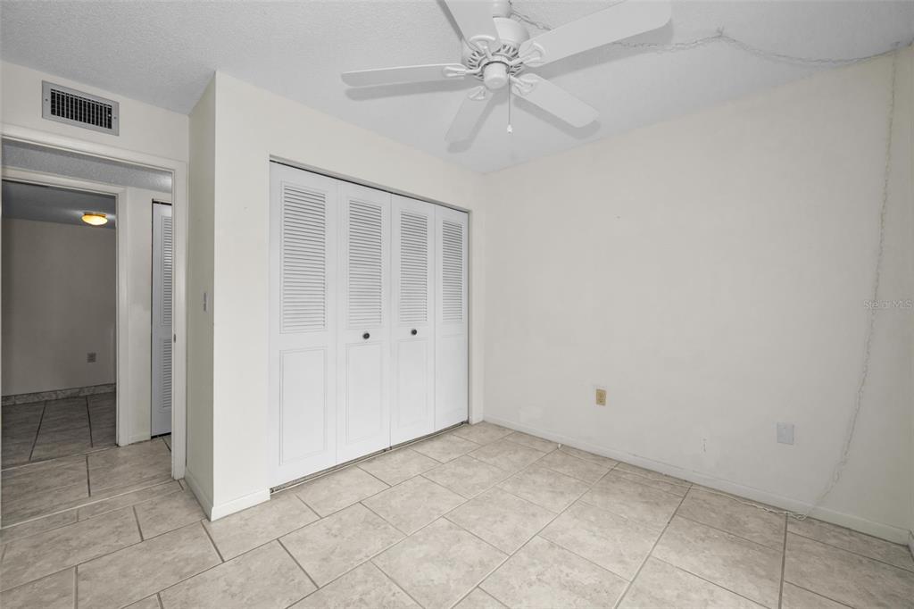 2687 Pine Ridge Way South, Unit B2 Palm Harbor, FL 34684 - Photo 26 of 68 an empty room with a ceiling fan and a shower
