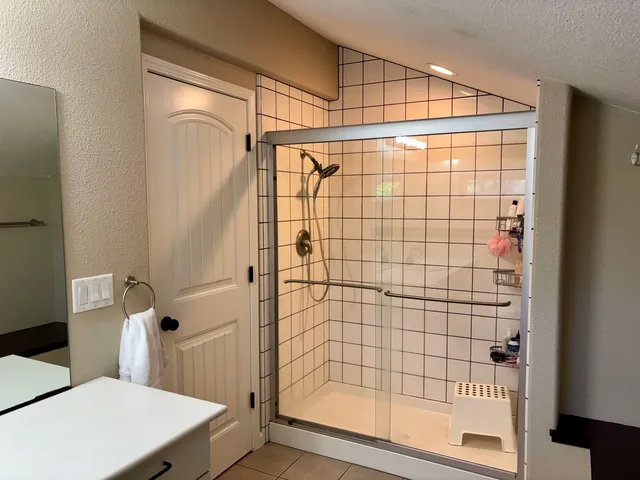 a bathroom with a shower and a toilet