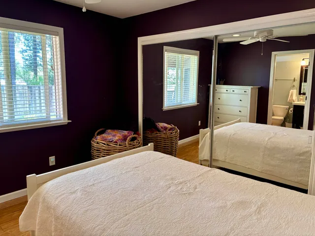 a bedroom with two beds and a window