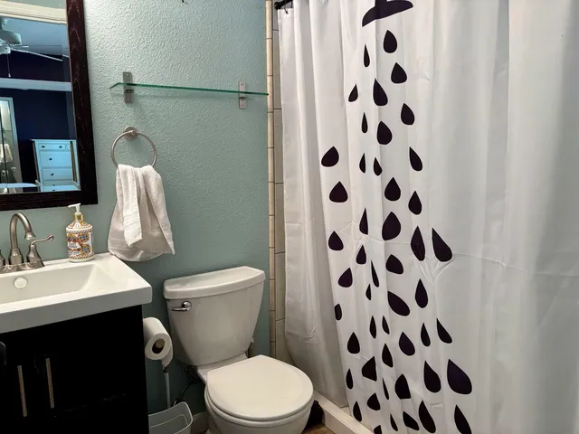 a white toilet sitting next to a bathroom sink