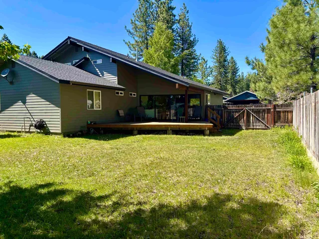 a house that has a big yard with wooden fence