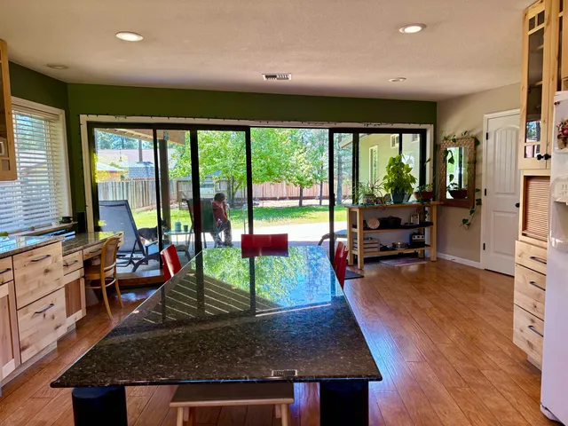 a living room with furniture stove and wooden floor