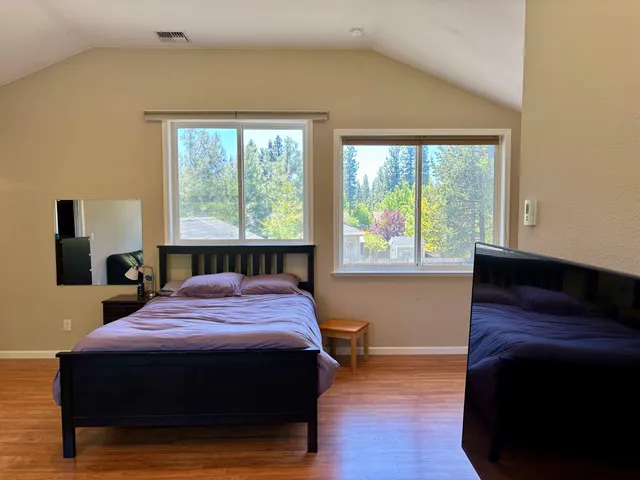 a bed room with a bed and a television