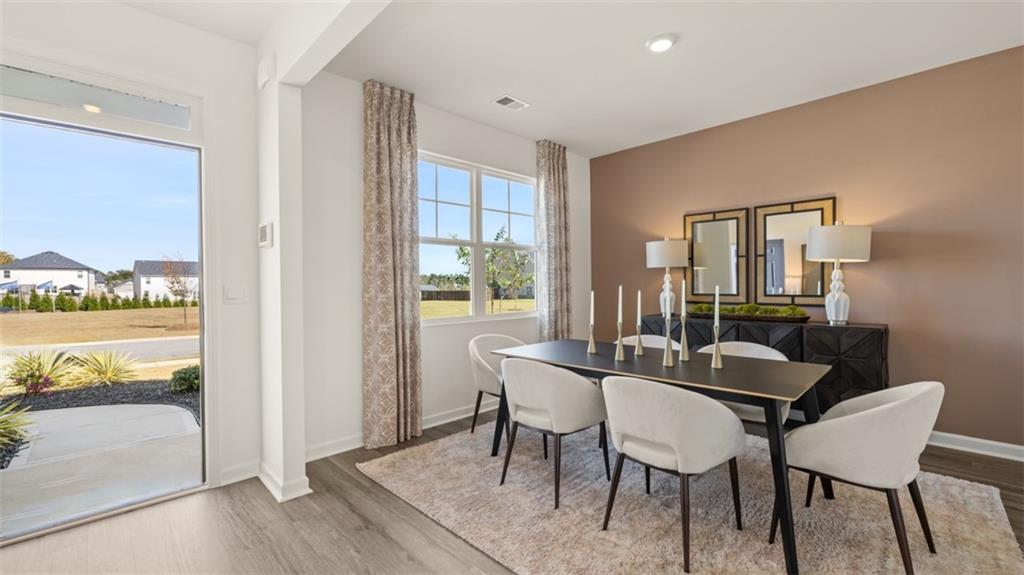 182 Aster Avenue Locust Grove, GA 30248 - Photo 20 of 48 a dining room with furniture and wooden floor
