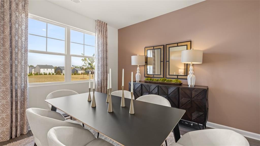 182 Aster Avenue Locust Grove, GA 30248 - Photo 22 of 48 a view of a dining room with furniture and a window