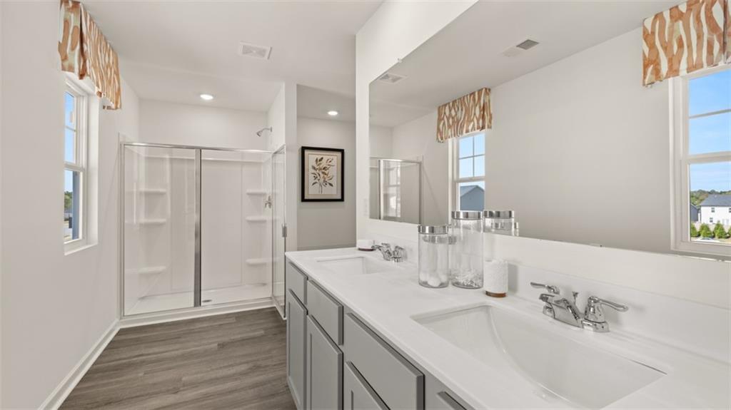 182 Aster Avenue Locust Grove, GA 30248 - Photo 28 of 48 a spacious bathroom with double vanity and a mirror