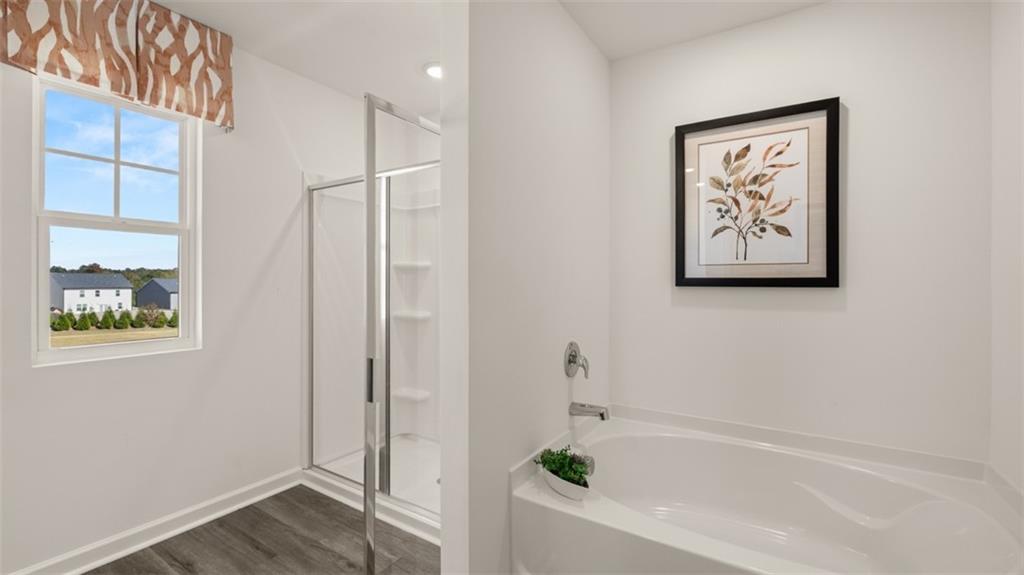 182 Aster Avenue Locust Grove, GA 30248 - Photo 29 of 48 a bathroom with a bathtub and a shower