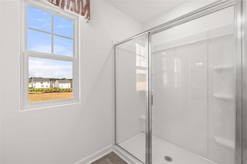 182 Aster Avenue Locust Grove, GA 30248 - Photo 32 of 48 a bathroom with a glass shower door
