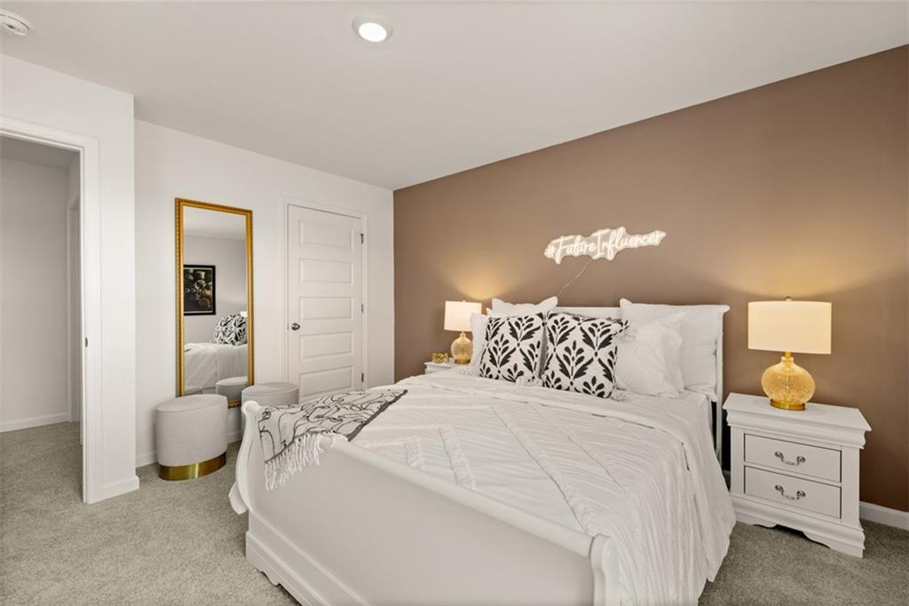 182 Aster Avenue Locust Grove, GA 30248 - Photo 37 of 48 a bedroom with a bed and a lamp