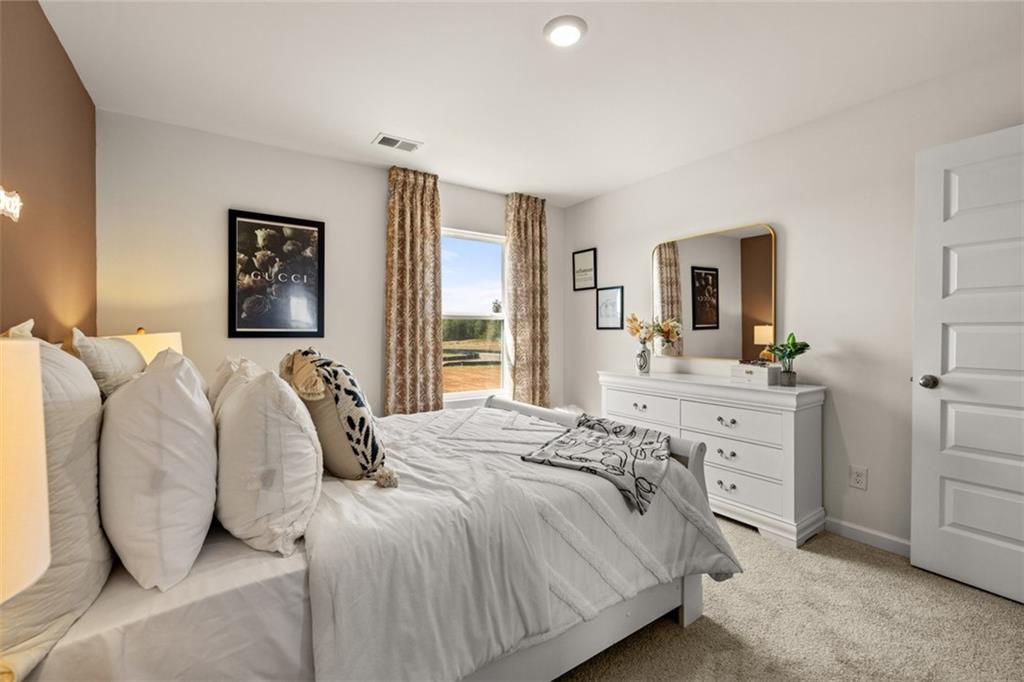 182 Aster Avenue Locust Grove, GA 30248 - Photo 38 of 48 a bedroom with a bed and a dresser