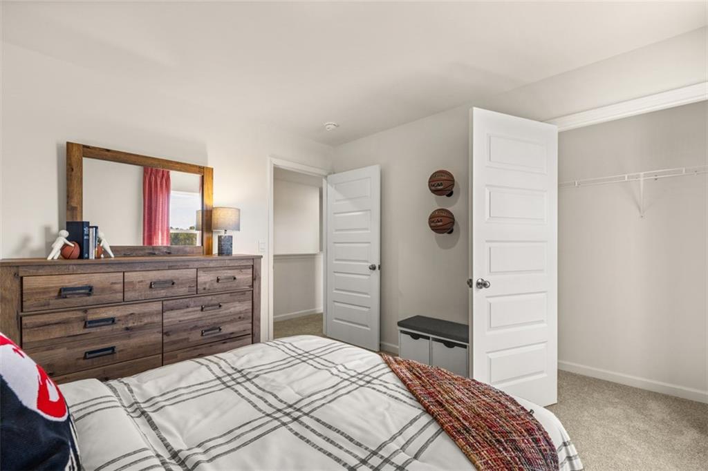 182 Aster Avenue Locust Grove, GA 30248 - Photo 41 of 48 a bedroom with a bed and a dresser