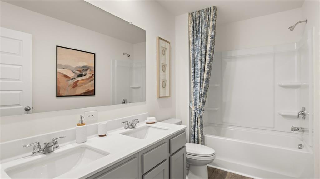 182 Aster Avenue Locust Grove, GA 30248 - Photo 44 of 48 a bathroom with a tub a sink and a large mirror