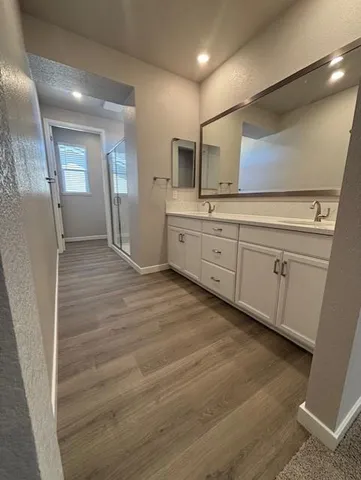 a large bathroom with a sink a mirror and a bathtub