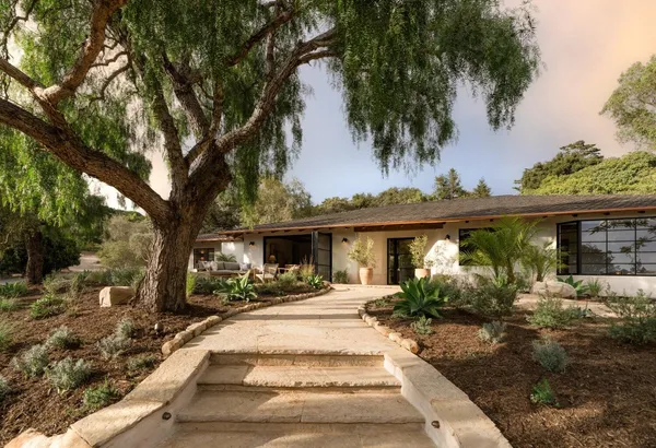 a front view of a house with garden