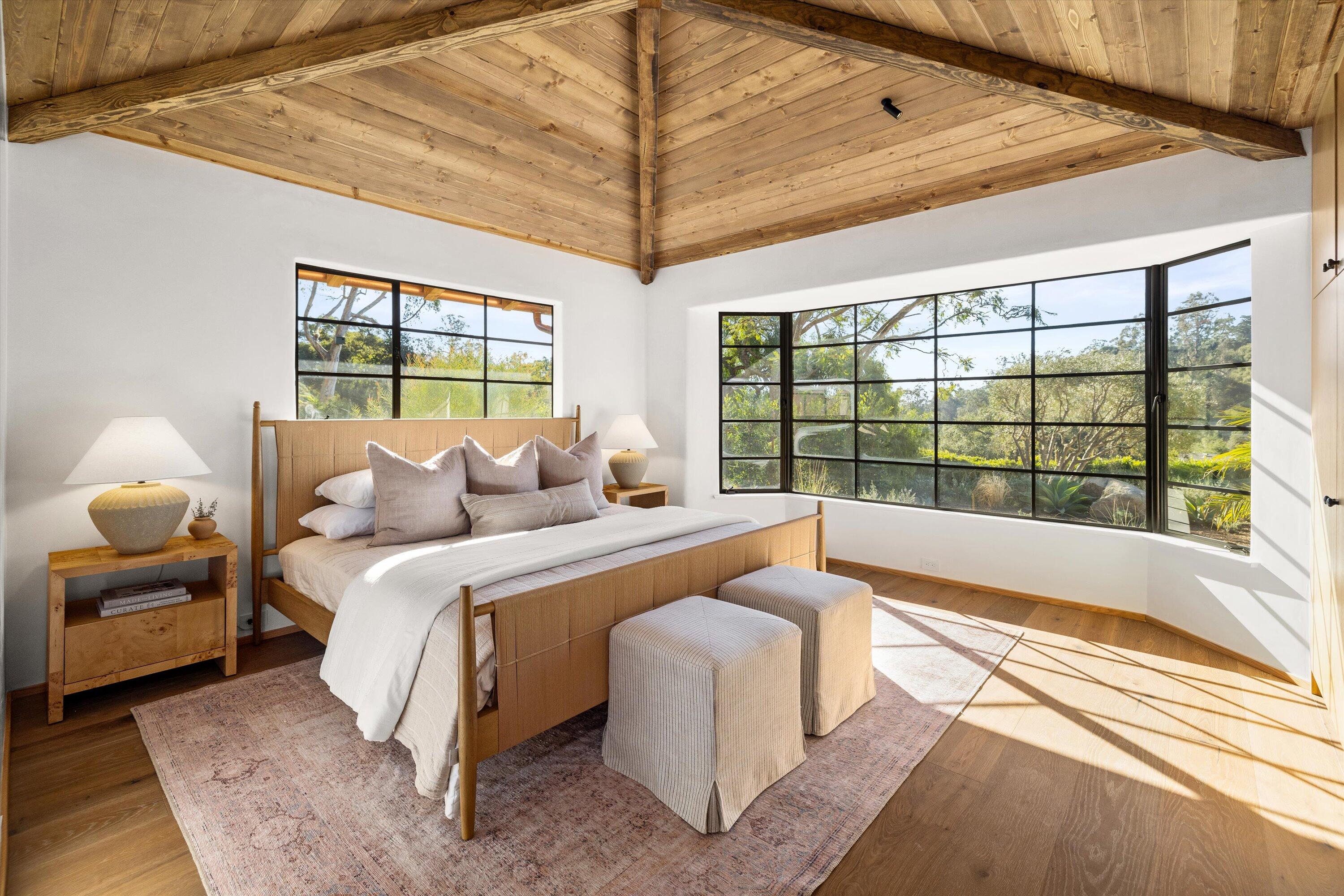 734 El Rancho Road Montecito, CA 93108 - Photo 11 of 24 a spacious bedroom with a bed and a large window