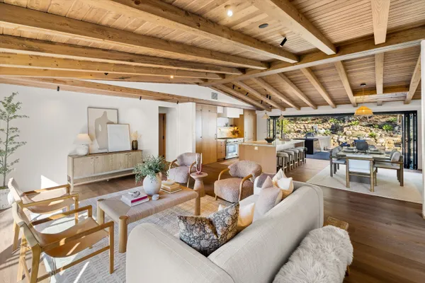 a living room with furniture and a chandelier