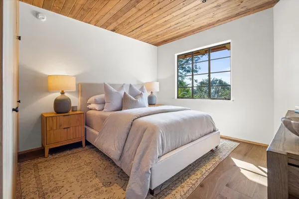 a bed room with a bed and a window