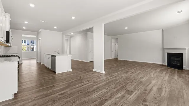 wooden floor fireplace and windows in an empty room