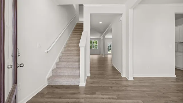 a view of an entryway with wooden floor