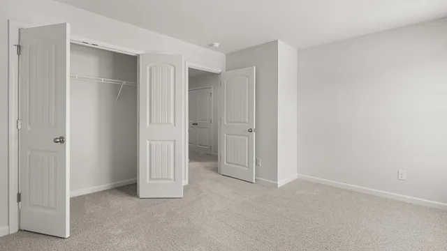 an aerial view of a house with garden space and a wooden bench