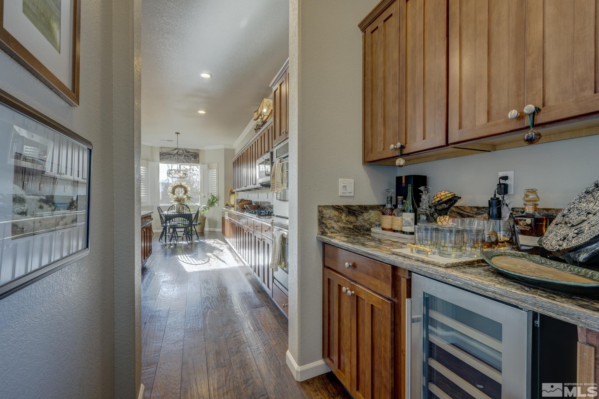 10585 Dillingham Drive Reno, NV 89521 - Photo 13 of 39 a kitchen with stainless steel appliances granite countertop wooden cabinets a sink and dishwasher a stove with wooden floor