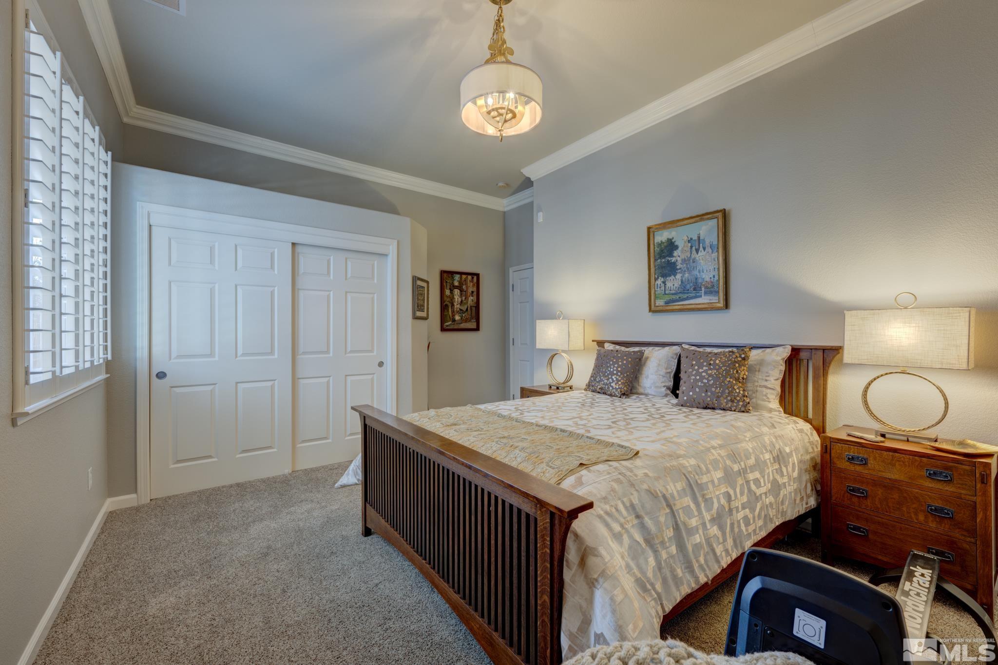 10585 Dillingham Drive Reno, NV 89521 - Photo 31 of 39 a bedroom with a bed and a chandelier