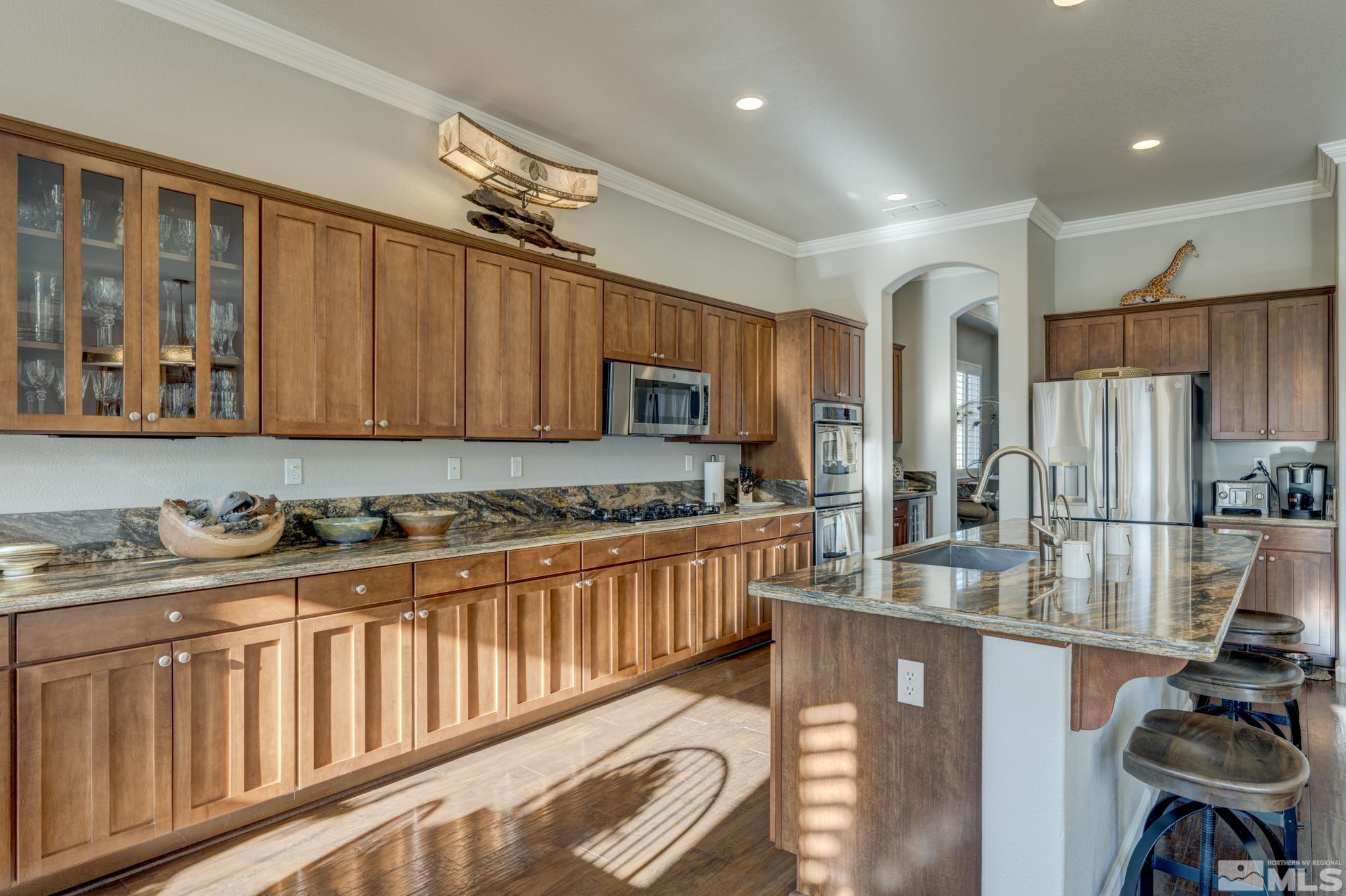 10585 Dillingham Drive Reno, NV 89521 - Photo 5 of 39 a kitchen with stainless steel appliances granite countertop a sink refrigerator and cabinets