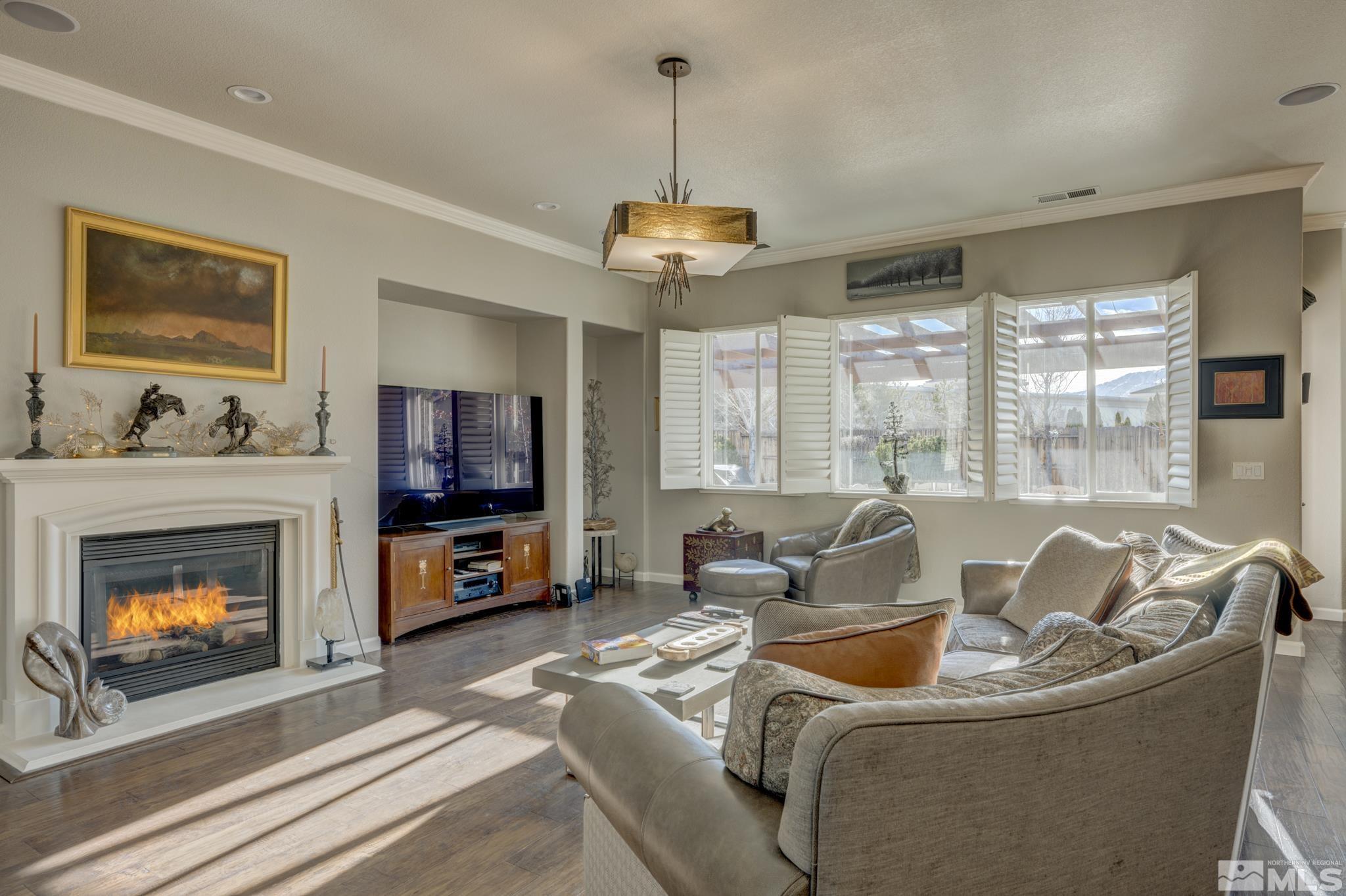 10585 Dillingham Drive Reno, NV 89521 - Photo 8 of 39 a living room with furniture a flat screen tv and a fireplace