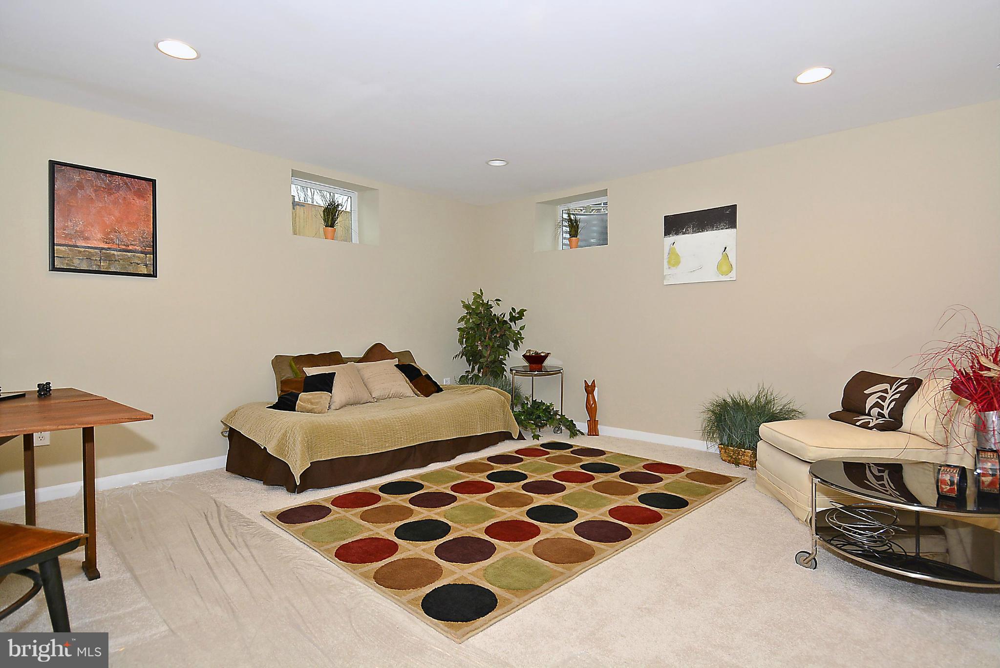 9313 Harvey Road Silver Spring, MD 20910 - Photo 22 of 28 a bedroom with a bed and a lamp