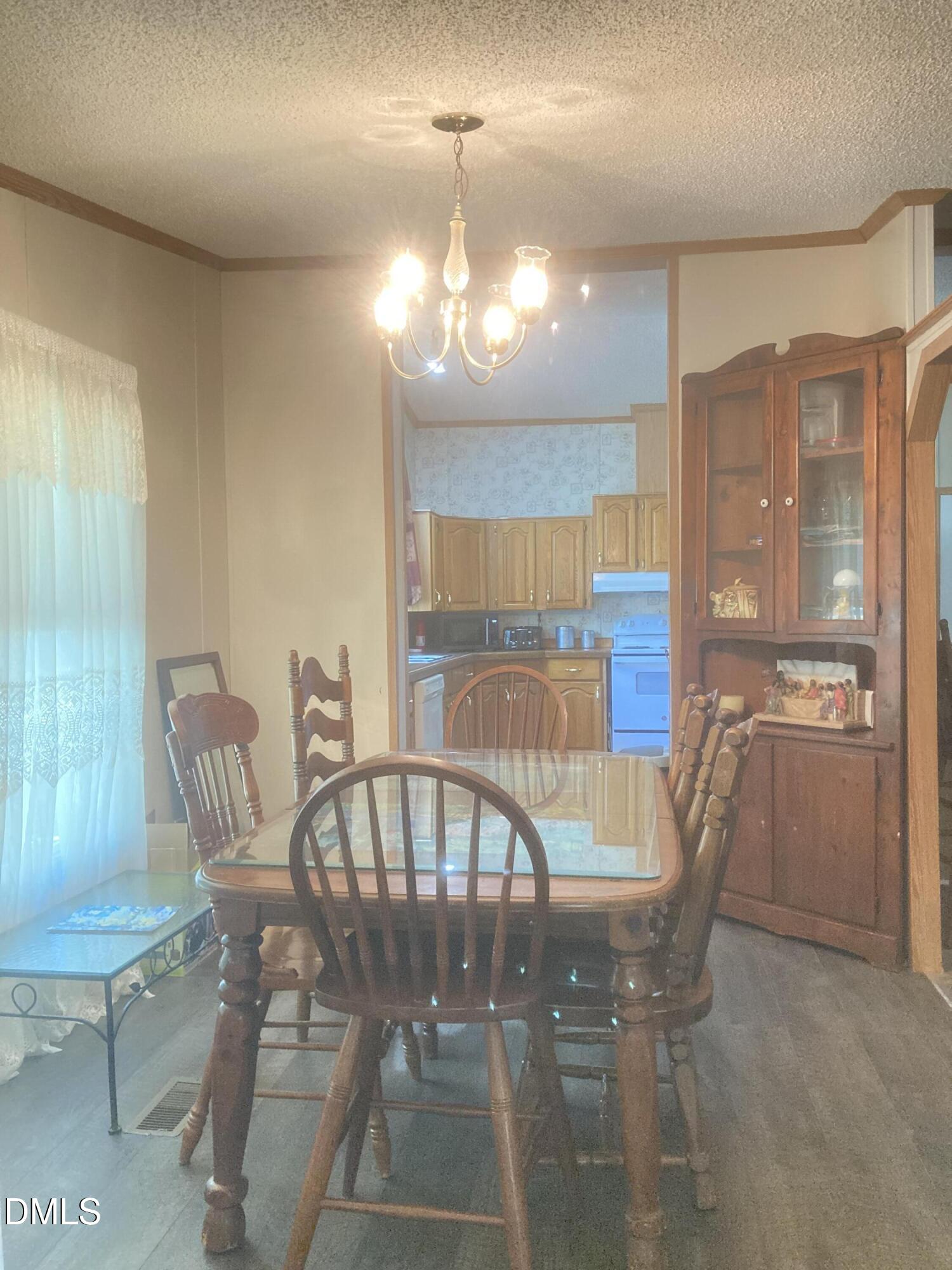 1586 Gum Swamp Church Road Greenville, NC 27834 - Photo 23 of 93 a view of a dining room with furniture and a chandelier