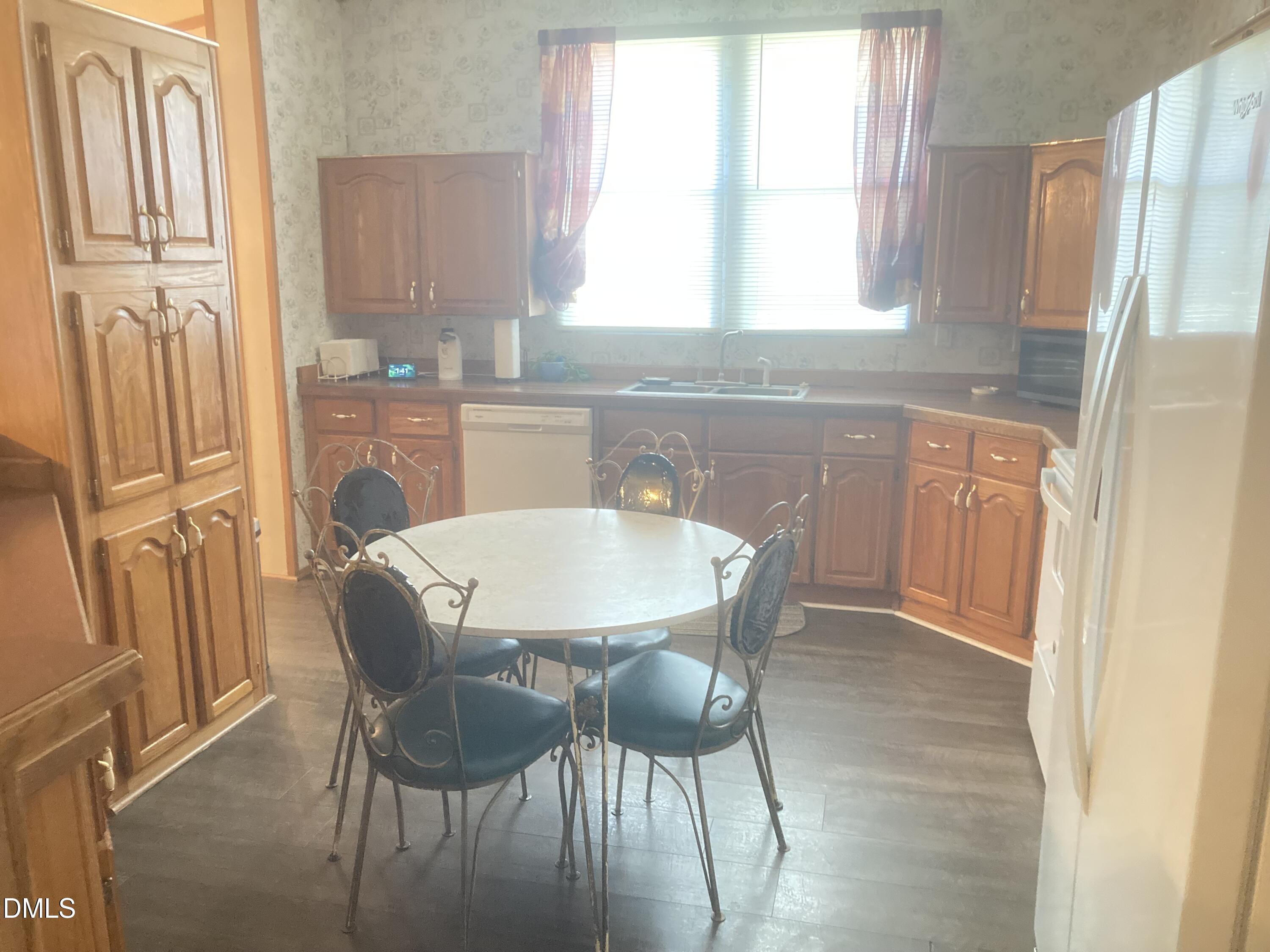 1586 Gum Swamp Church Road Greenville, NC 27834 - Photo 32 of 93 a kitchen with stainless steel appliances granite countertop a table chairs and a refrigerator