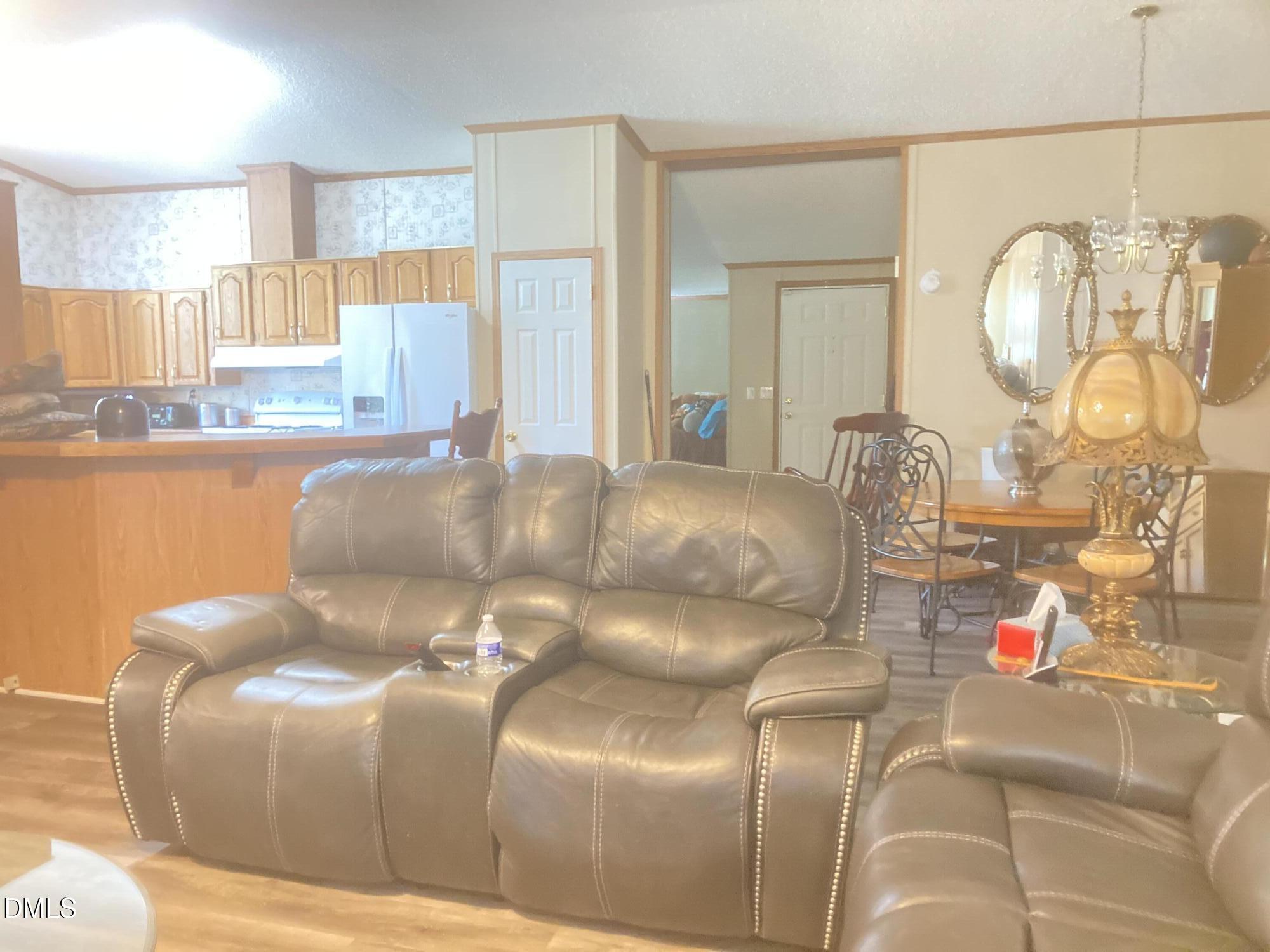 1586 Gum Swamp Church Road Greenville, NC 27834 - Photo 42 of 93 a living room with couches and dining table with wooden floor