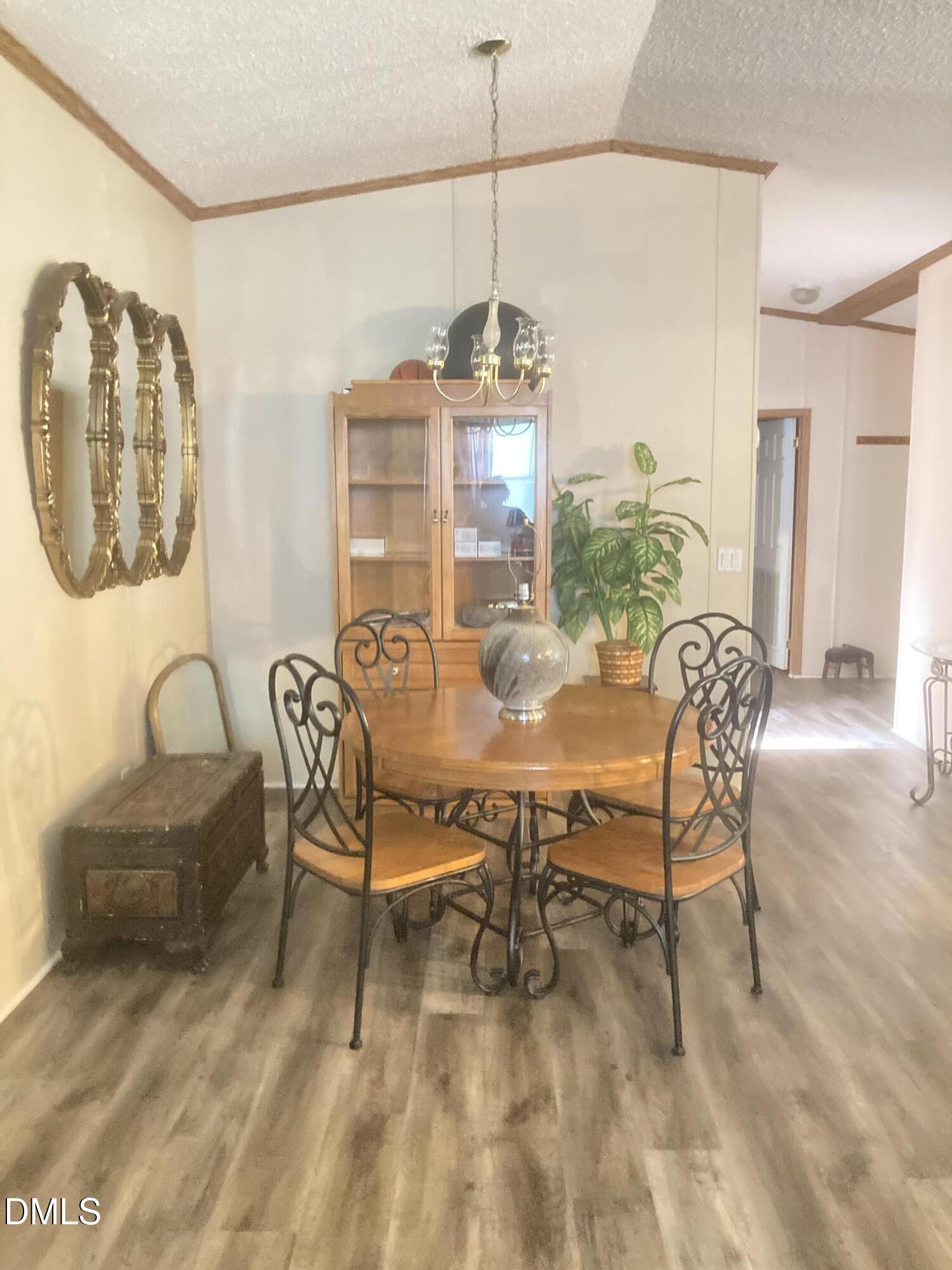1586 Gum Swamp Church Road Greenville, NC 27834 - Photo 43 of 93 a dining room with furniture a chandelier and wooden floor