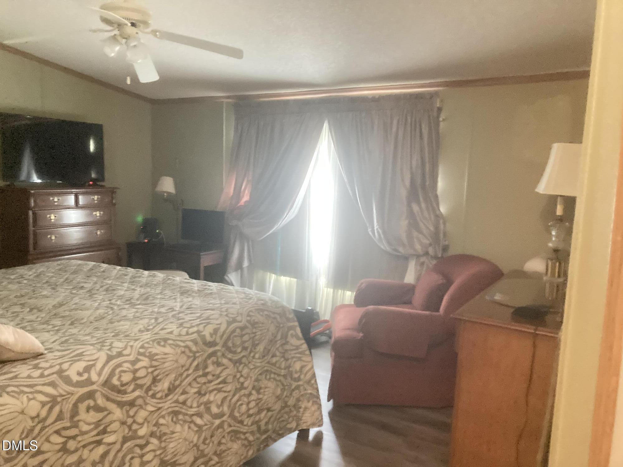 1586 Gum Swamp Church Road Greenville, NC 27834 - Photo 62 of 93 a bedroom with a bed window and couch