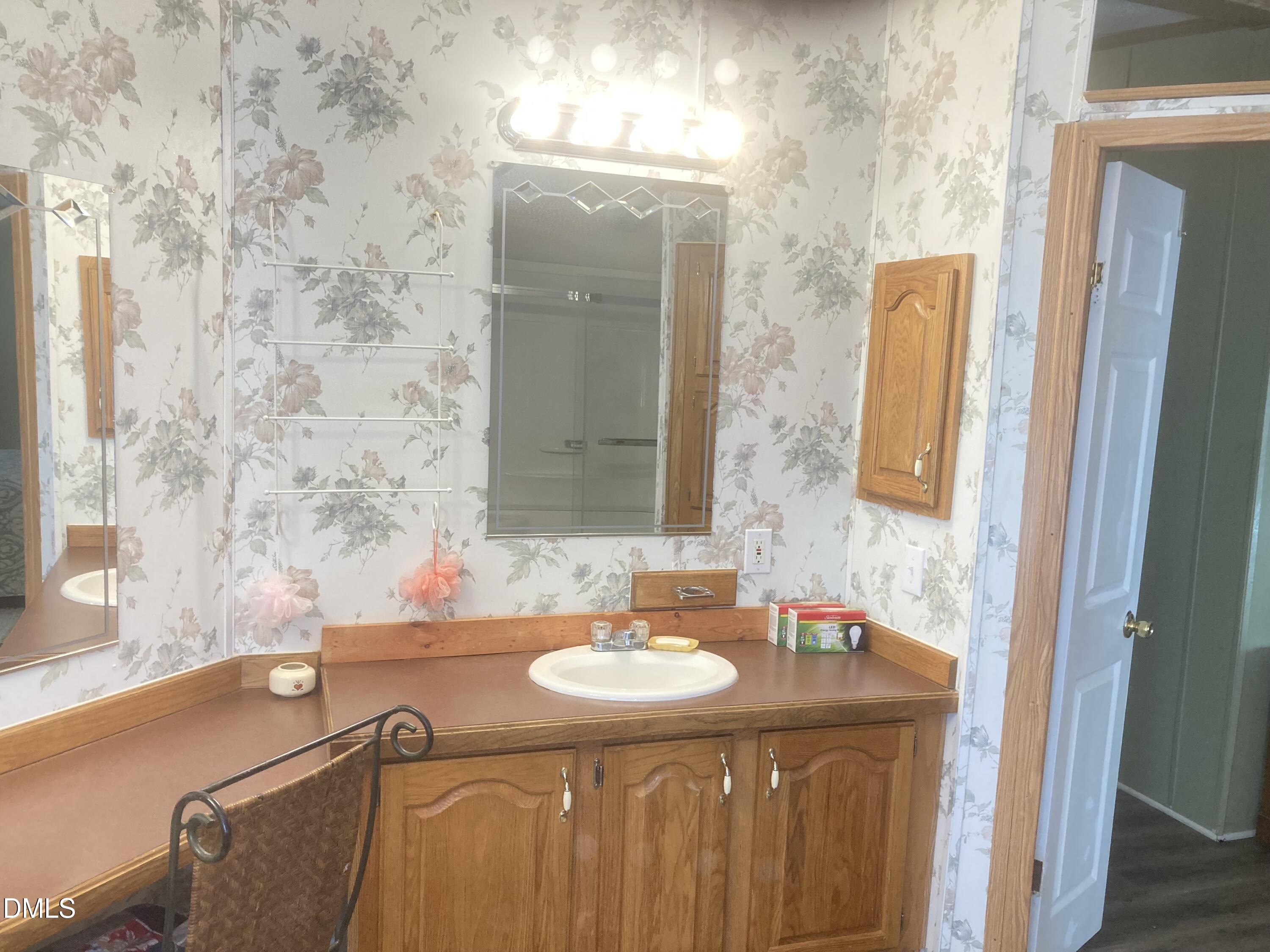 1586 Gum Swamp Church Road Greenville, NC 27834 - Photo 68 of 93 a bathroom with a granite countertop sink a mirror and a bathtub