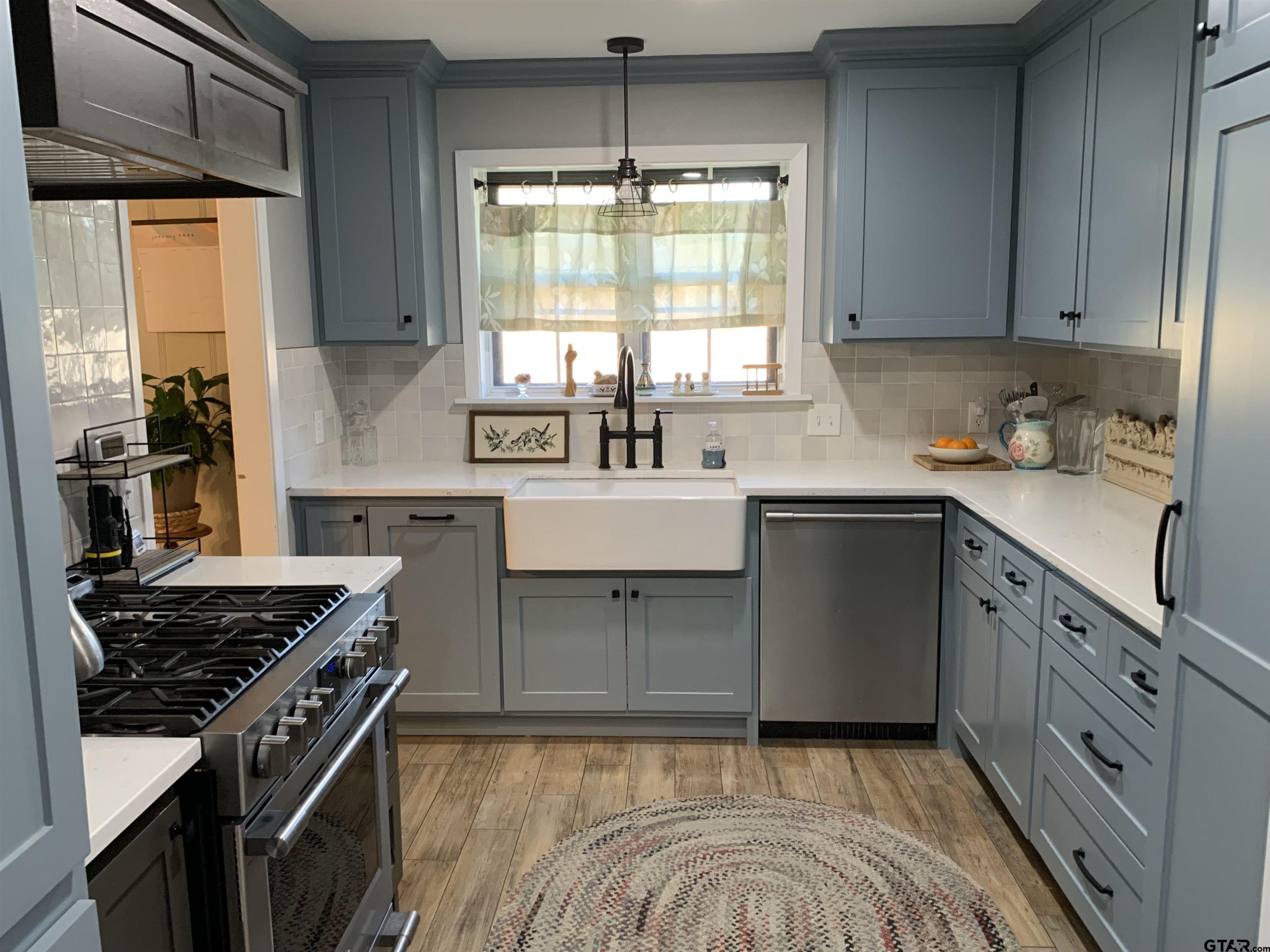 800 Neches Drive Tyler, TX 75702 - Photo 11 of 26 a kitchen with a sink stove top oven and cabinets