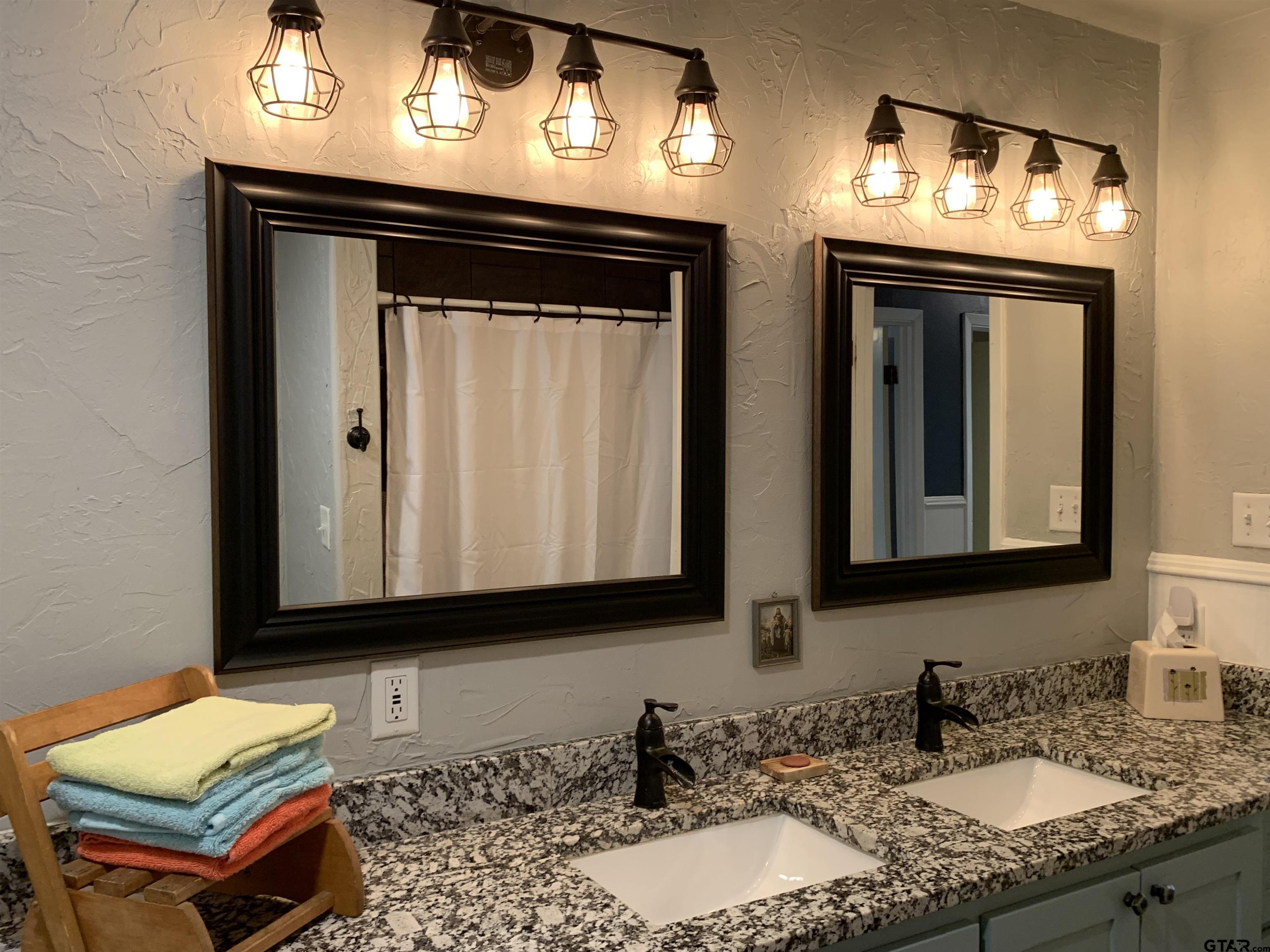 800 Neches Drive Tyler, TX 75702 - Photo 15 of 26 a bathroom with 2 sink and a mirror