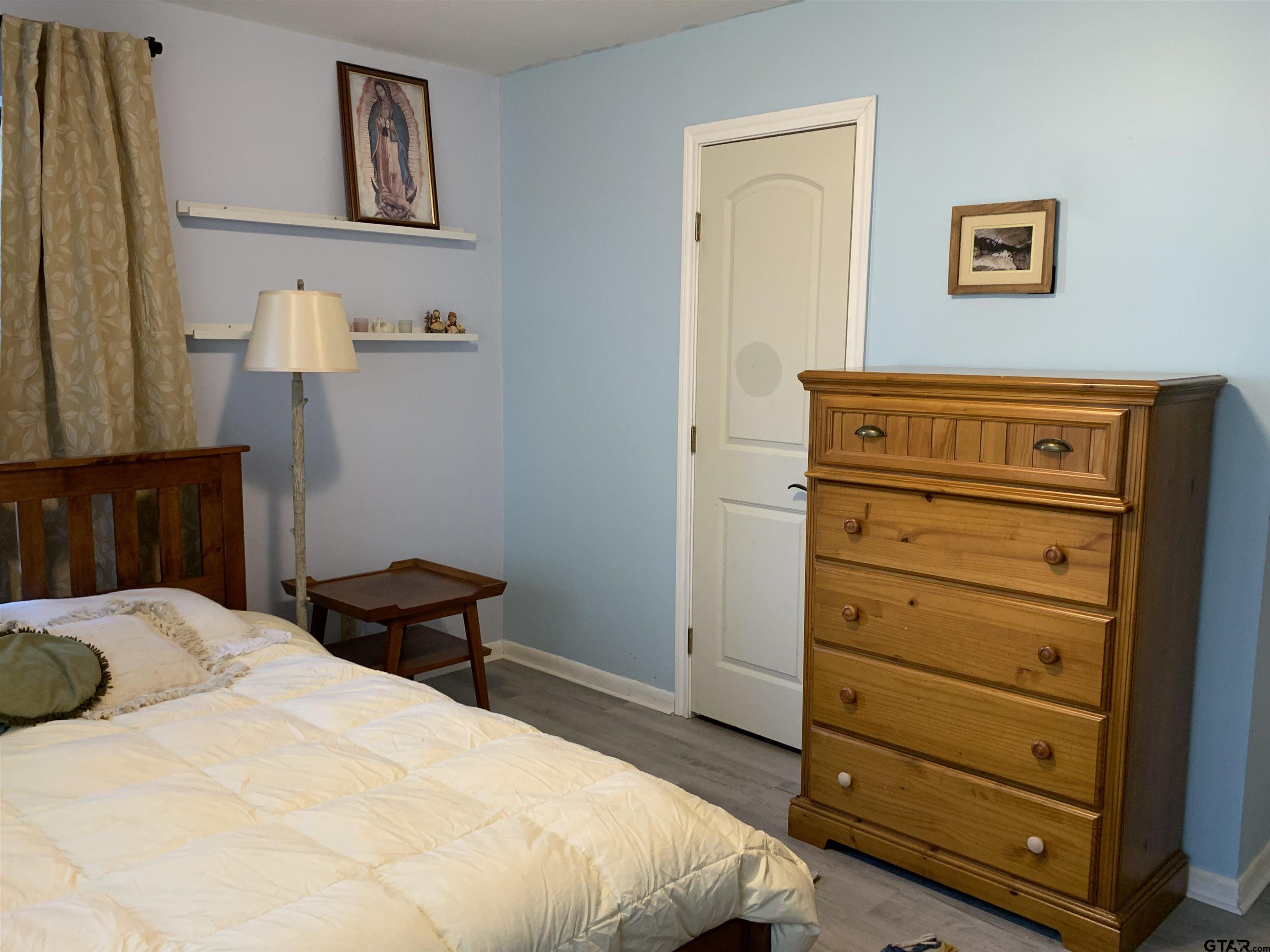 800 Neches Drive Tyler, TX 75702 - Photo 18 of 26 a bedroom with a bed and cabinet