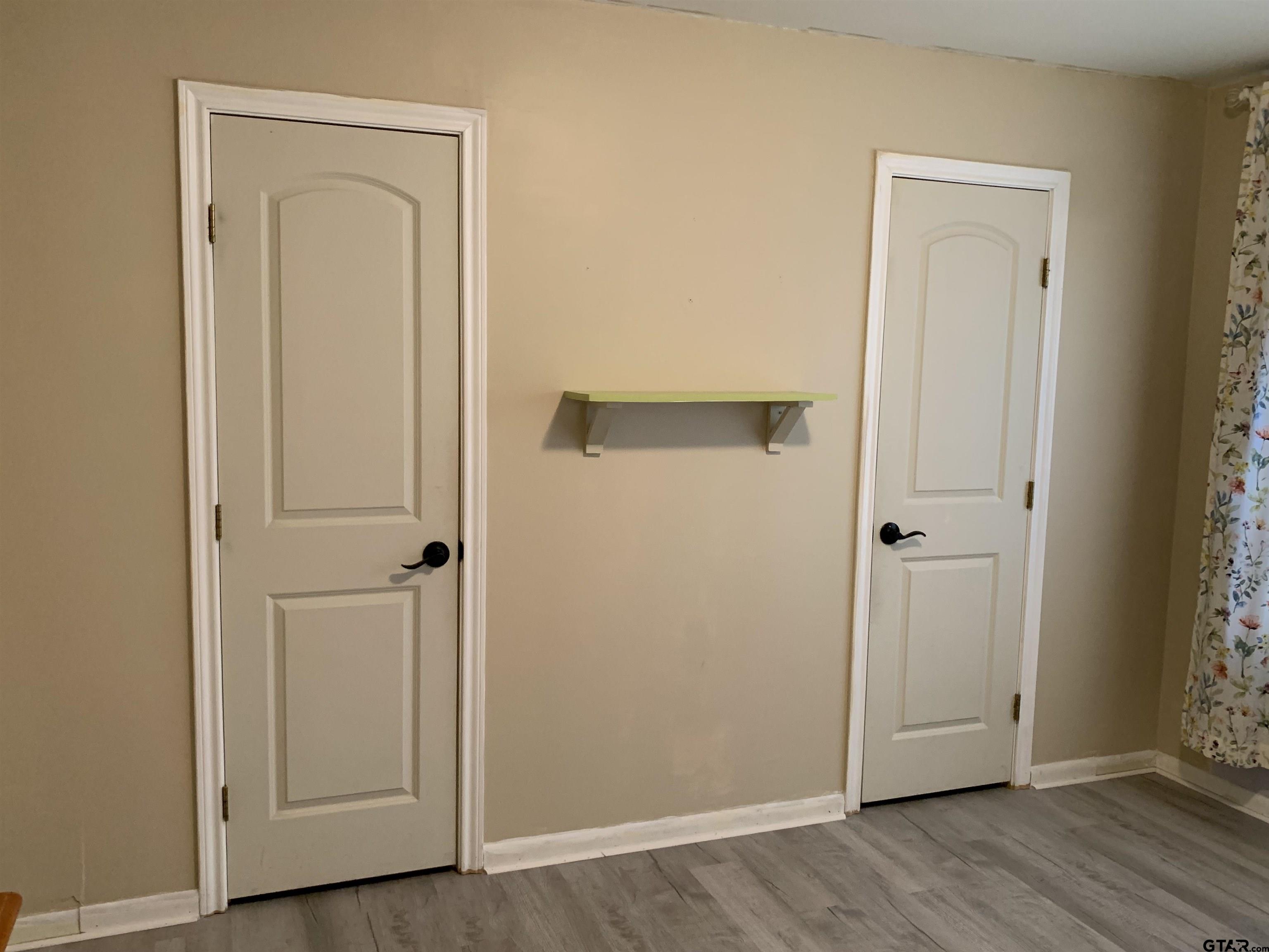 800 Neches Drive Tyler, TX 75702 - Photo 20 of 26 an empty room with wooden floor and closet area