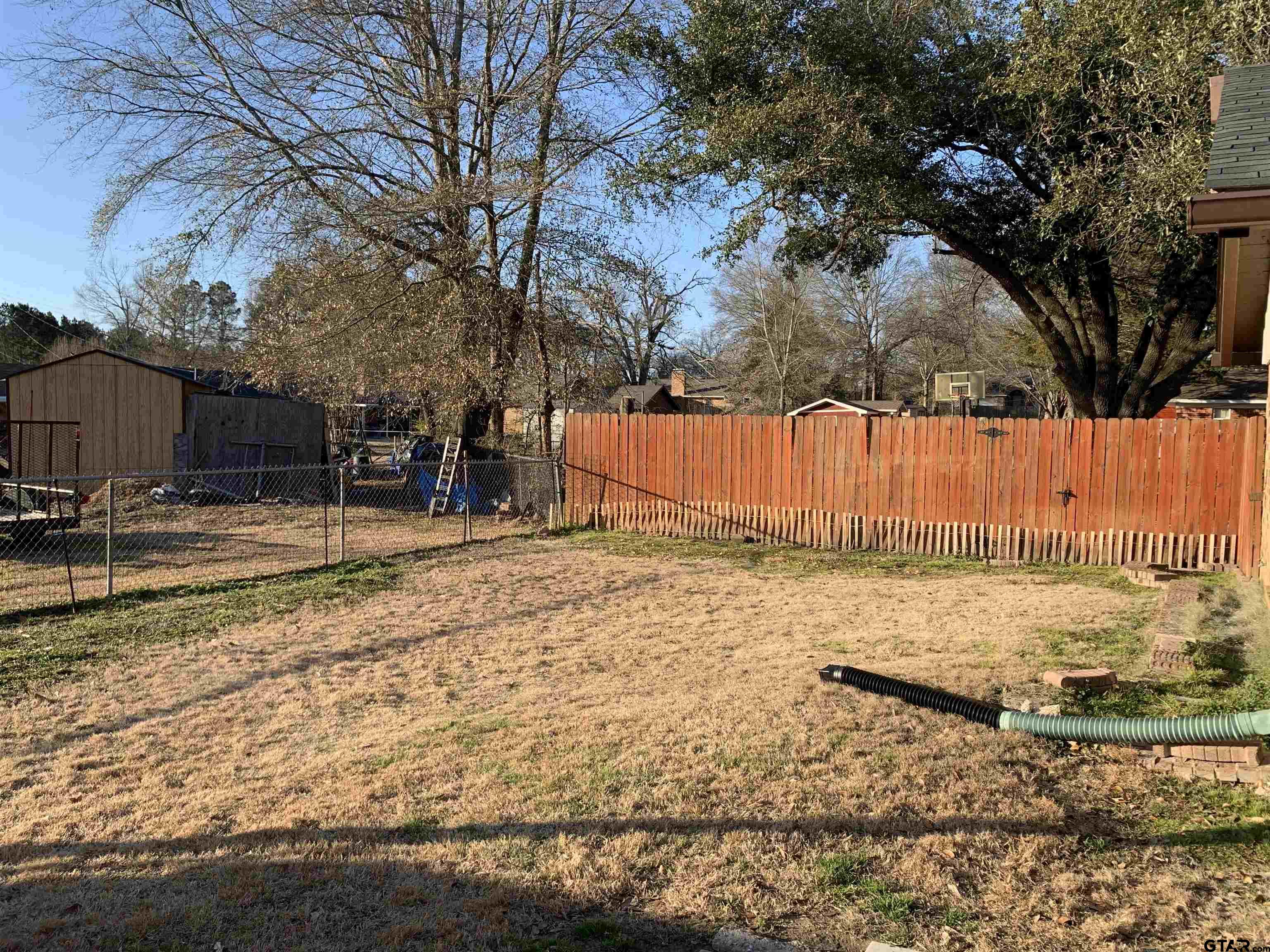 800 Neches Drive Tyler, TX 75702 - Photo 25 of 26 a backyard of a house with large trees